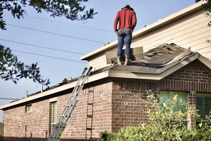 Professional roofer working on a residential roof in Emerald Valley